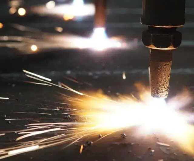 Oxy-fuel flame cutting torches in operation